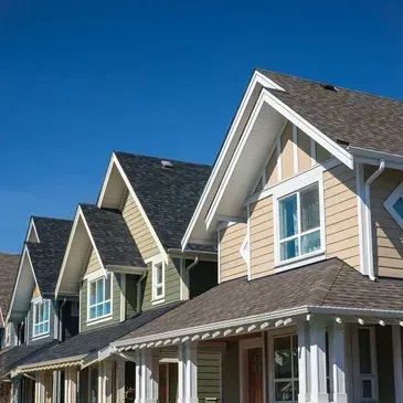 Row of homes with new shingle roofs and siding